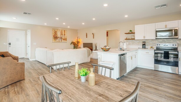 A modern kitchen with white cabinets, a stainless steel oven, and a microwave. - Golfer's Oasis! Mtn-view Arizona Desert Escape (Wickenburg)
