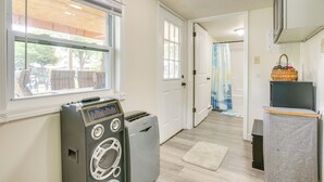 A laundry room with a washing machine, dryer, and a small table with a basket. - Boat Dock: Couple's Grand Lake Getaway! (St. Marys)