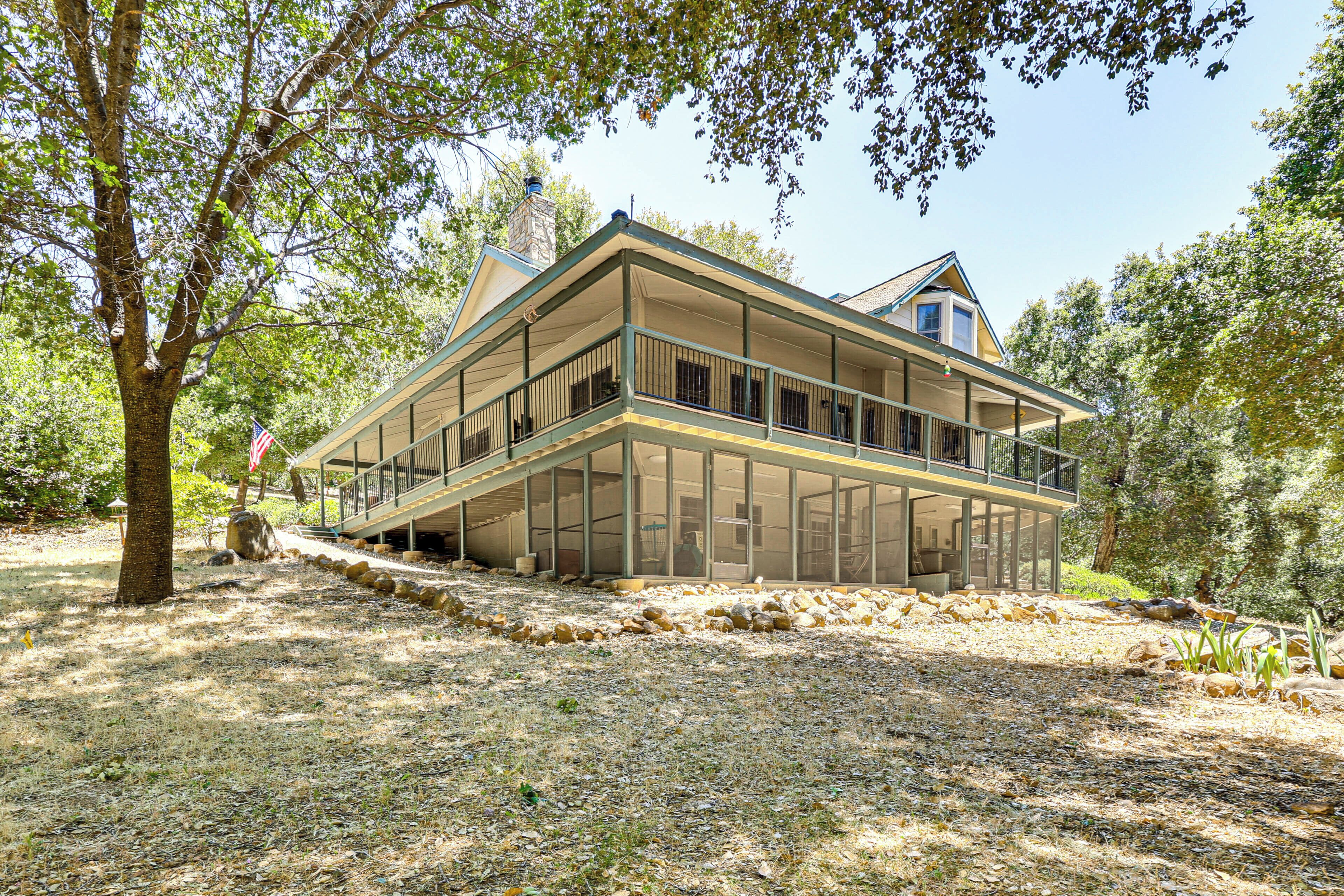 A two-story house with a balcony and a covered porch area.