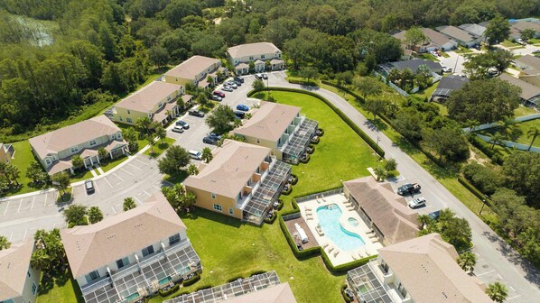 A residential area with multiple two-story houses, a swimming pool, and a parking lot.