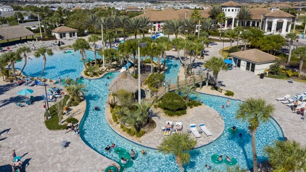 A resort with multiple swimming pools, palm trees, and lounge areas. - Themed 5Bd Family Villa w Pool Spa Near Disney (Kissimmee)