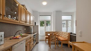 A kitchen with wooden cabinets, a dishwasher, and a window.