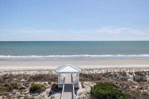 A beach view with a small white gazebo structure.