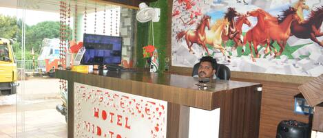 A hotel reception desk with a sign reading "HOTEL MIDTOWN".