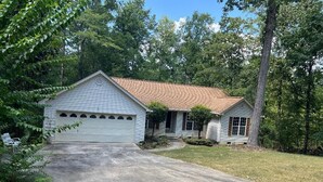 A single-story house with a garage, a front porch, and a driveway. - Delightful 3-bedroom, 2 bath home in Savannah Lakes Village--McCormick, SC (McCormick)