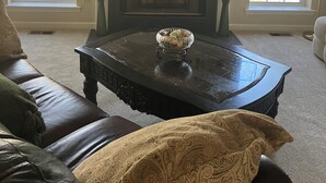 A living room with a fireplace, a coffee table, and a sofa. - Delightful 3-bedroom, 2 bath home in Savannah Lakes Village--McCormick, SC (McCormick)