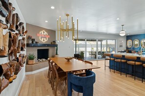 A modern interior with a dining area, bar, and a wall of boots. - Scottsdale Family Retreat: Heated Pool, Hot Tub, Fire Pit, Putting Green, Pin... (Scottsdale)