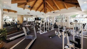 A gym with treadmills, weight machines, and a high wooden ceiling. - Escape 48! Heated Pool, Hot Tub, Fitness Center, walk to Coffee, Grocery (Phoenix)