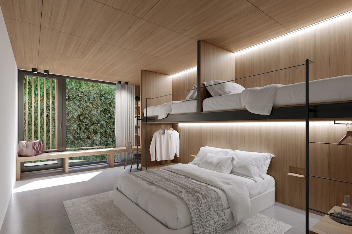 A modern bedroom with a bunk bed, a desk, and a bench by a window overlooking greenery.