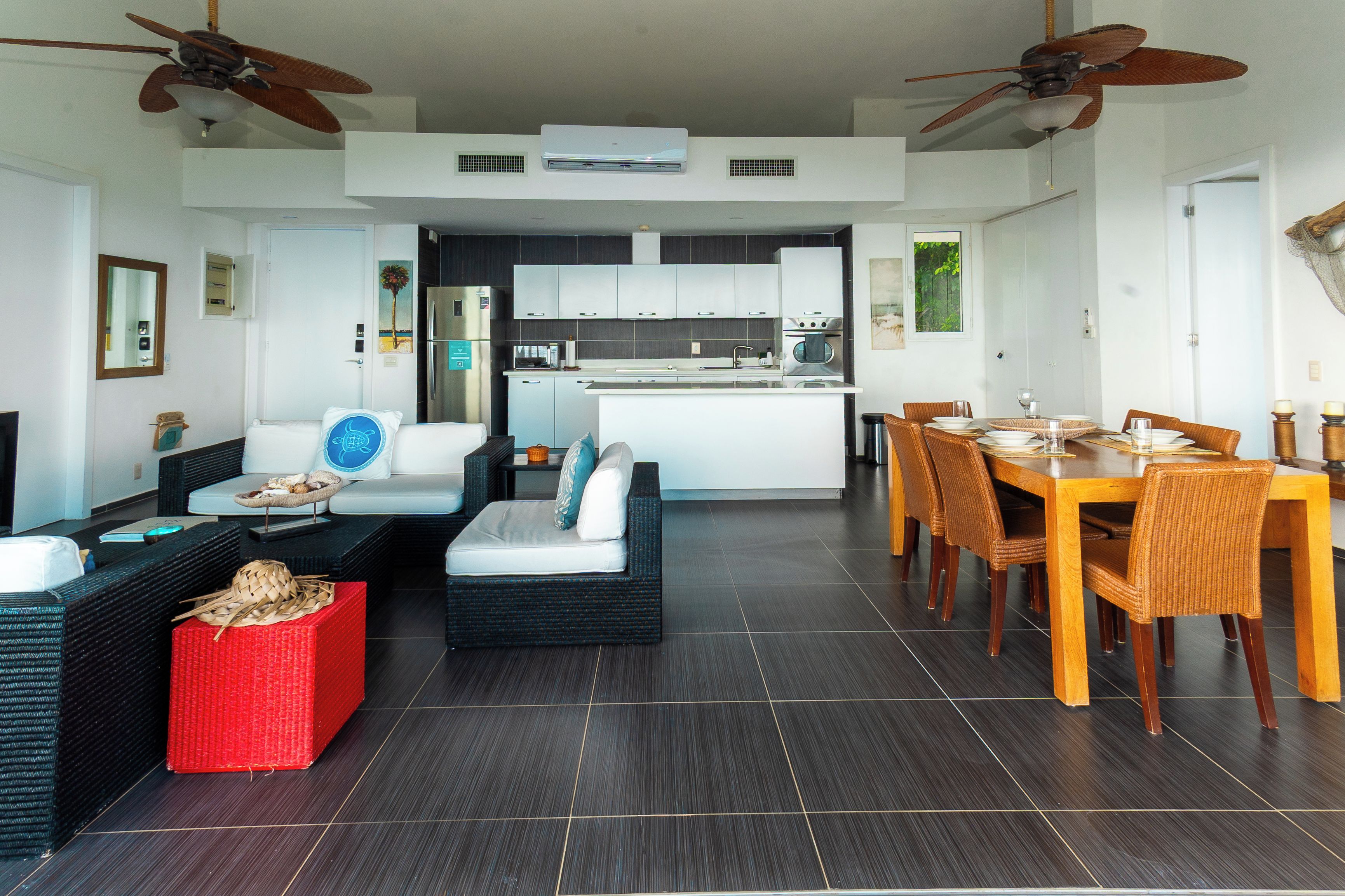 Een moderne woonruimte met een eettafel, banken en een keuken op de achtergrond.