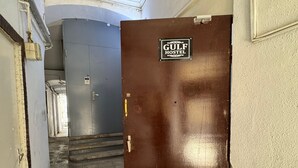 A hallway with a brown door labeled "GULF HOSTEL." - Gulf Hostel (Baku)