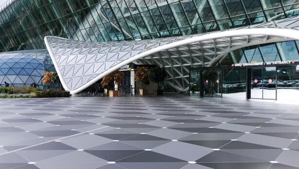 A modern building with a glass facade and a geometric entrance canopy. - Gulf Hostel (Baku)