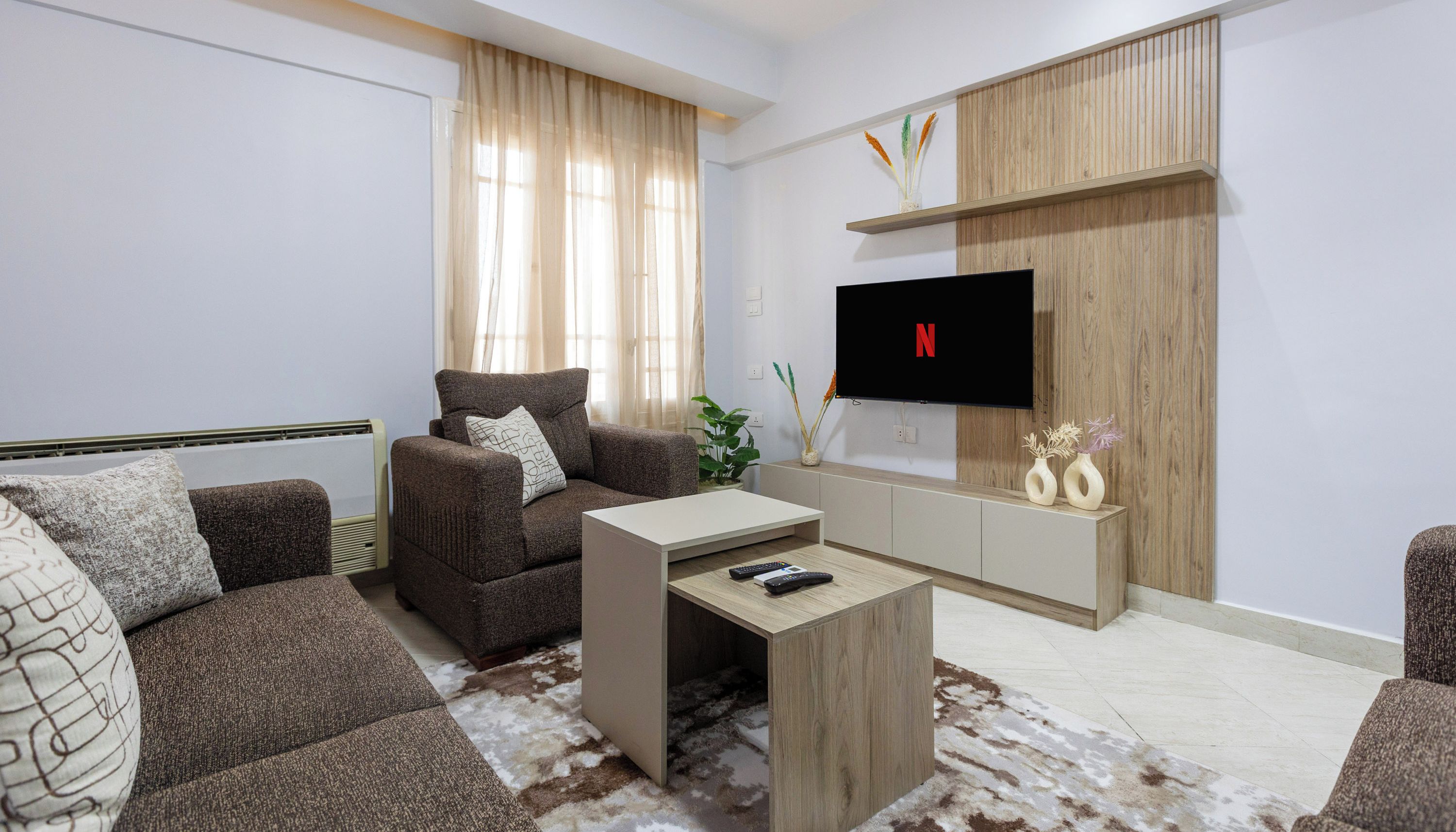 A modern living room with a sofa, coffee table, and TV.