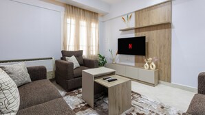 A modern living room with a sofa, coffee table, and TV. - Prime Select Raml Station Alexandria (Alexandria)