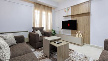 A modern living room with a sofa, coffee table, and TV.