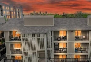 A multi-story building with balconies, a central entrance, and a flat roof. - Campus West Nest - King Bed + Walk to CSU (Fort Collins)