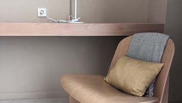 A modern chair with a cushion and a desk lamp.