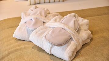 A neatly folded towel with a built-in pillow on a textured surface.
