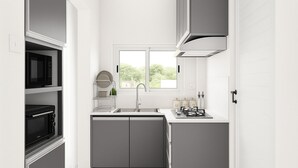 A compact kitchen with a microwave, toaster, and gas stove. - Fully Equipped Rooftop house with private terrace in Beau Bois, St-Pierre, Moka (Saint Pierre)