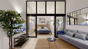 A modern living room with a sofa, a coffee table, and a large plant. - Apartment 0 Bedrooms MFA, 400m Praia dos Pescadores (Albufeira)