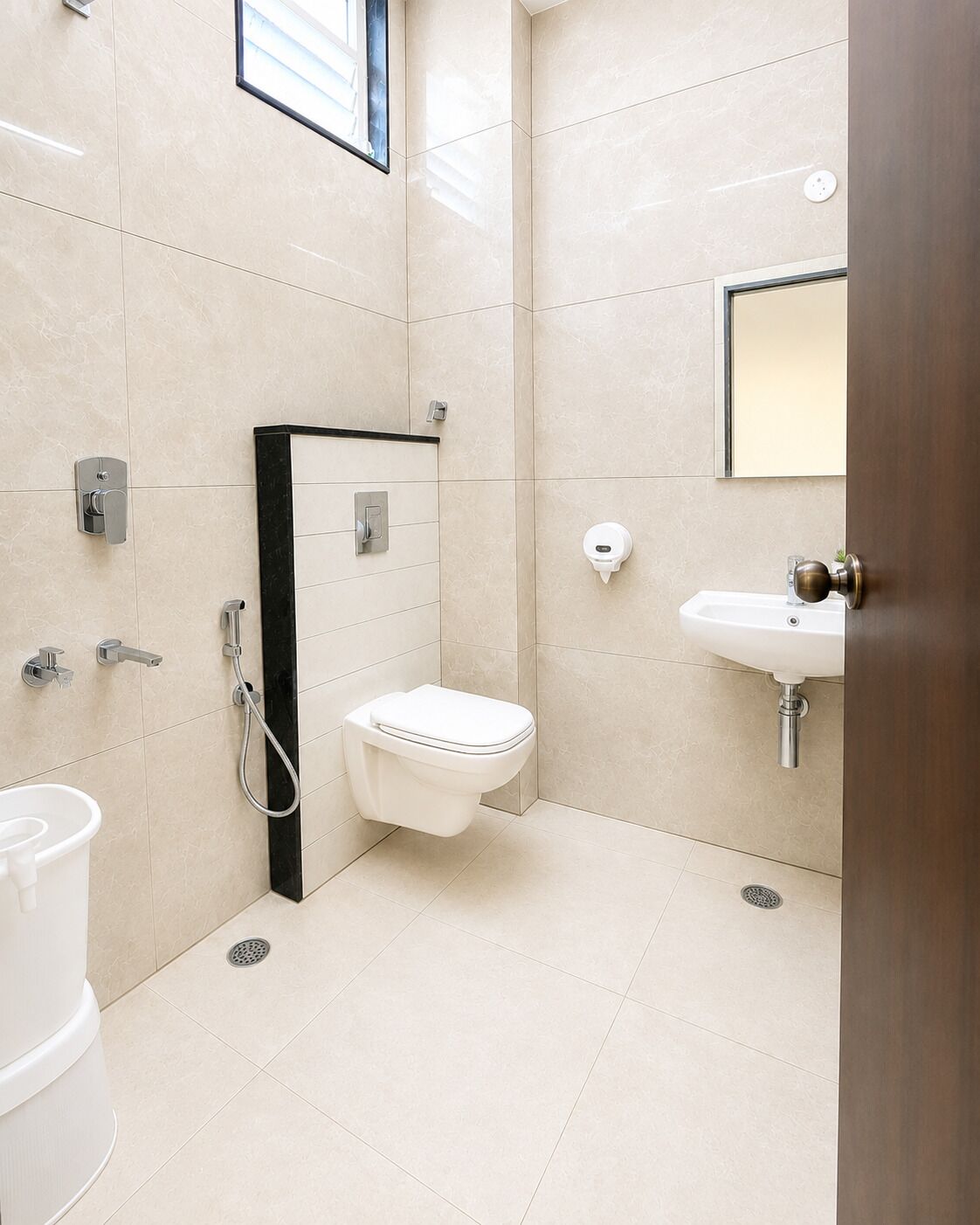 A modern bathroom with a toilet, bidet, and sink.