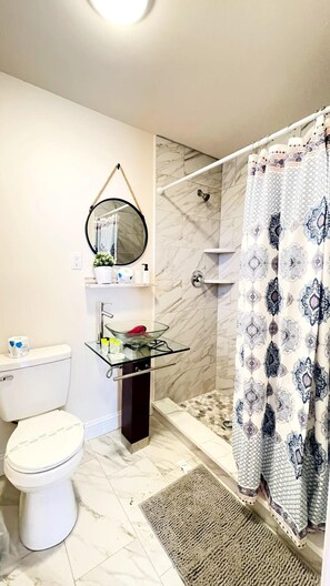 Shower, hair dryer, towels, shampoo