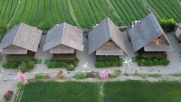 A row of traditional-style houses with sloped roofs, arranged in a linear fashion on a flat landscape.