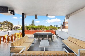 A rooftop terrace with outdoor seating, a table, and a projector. - Charming Studio in Subiaco w/ Free WiFi & Parking! (Subiaco)