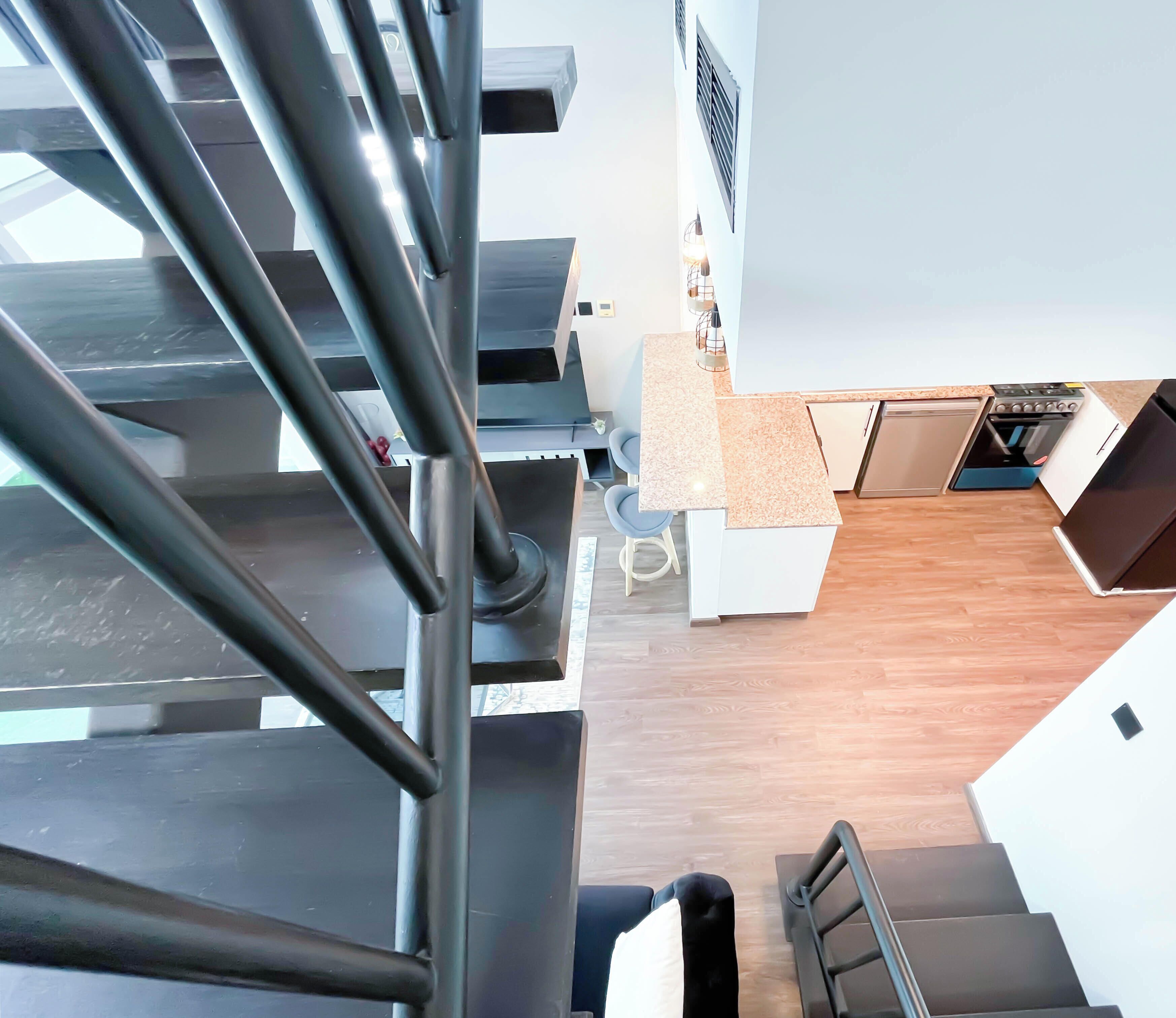 A modern kitchen with a built-in stove, dishwasher, and refrigerator.