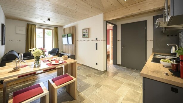 A modern kitchen with a wooden countertop and a built-in oven.