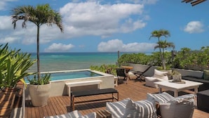 A wooden deck with a pool, lounge chairs, and potted plants. - Beachfront Luxury + Rooftop Oasis Tankah Bay (Tulum)