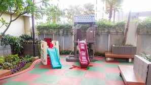 A playground with two slides and a climbing structure. - Elegant Studio Apartment Silkwood Residences Near Alam Sutera (Tangerang)