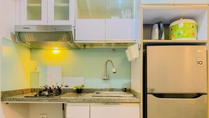 A compact kitchen with a stainless steel refrigerator, a built-in oven, and a sink. - Warm And Cozy Stay 2Br Pakubuwono Terrace Apartment (Jakarta)