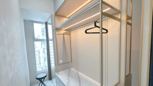 A modern bathroom with a marble vanity, a hanging shower, and a view of the city through a large window. - Great Choice And Fabulous 2Br At Benson Supermall Mansion Apartment (Surabaya)