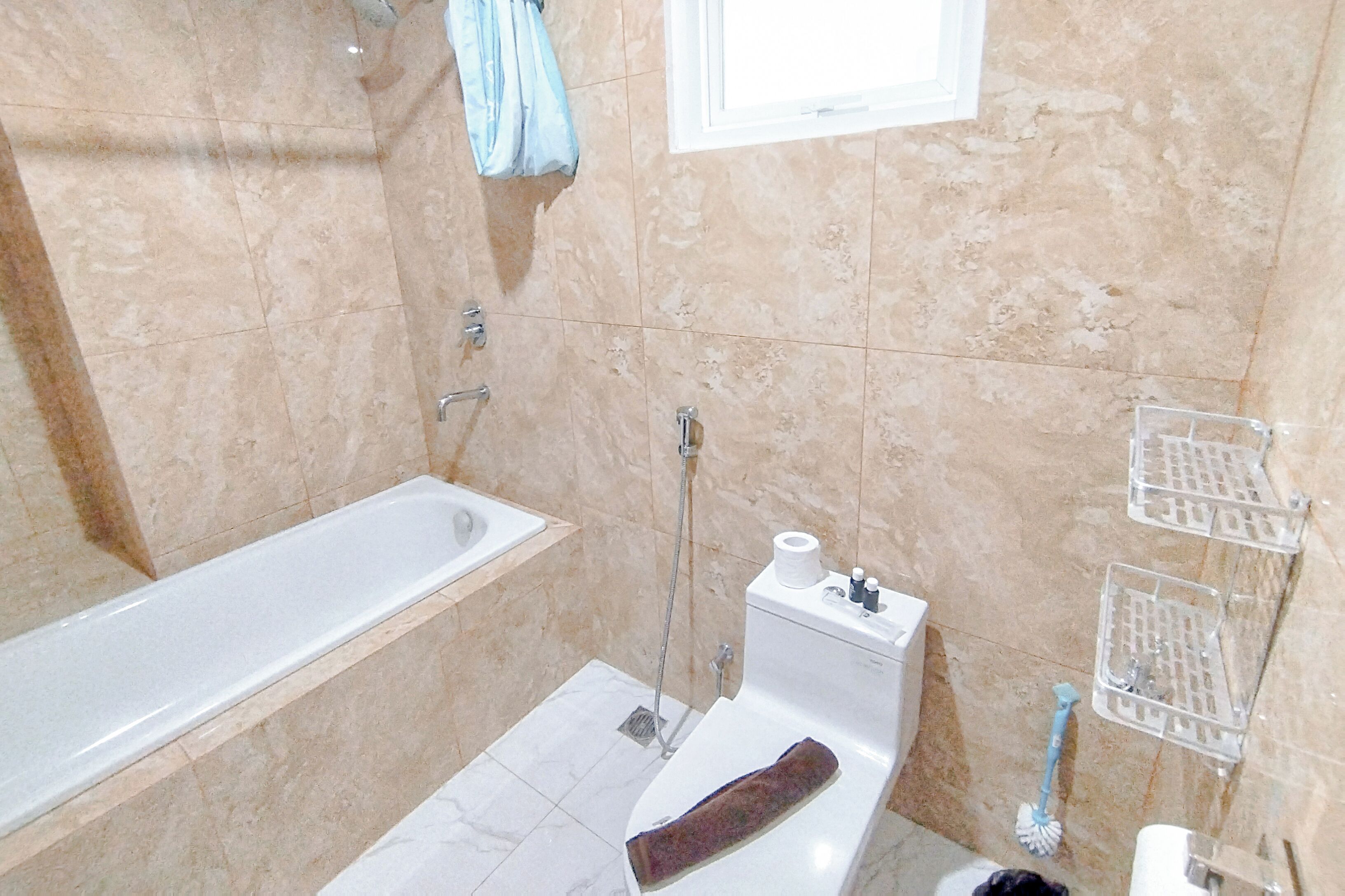 A bathroom with a bathtub, toilet, and shower.