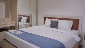 A hotel room with a large bed, a bedside table, a mirror, and a wardrobe. - Great Choice 2Br At Bintaro Icon Apartment (South Tangerang)