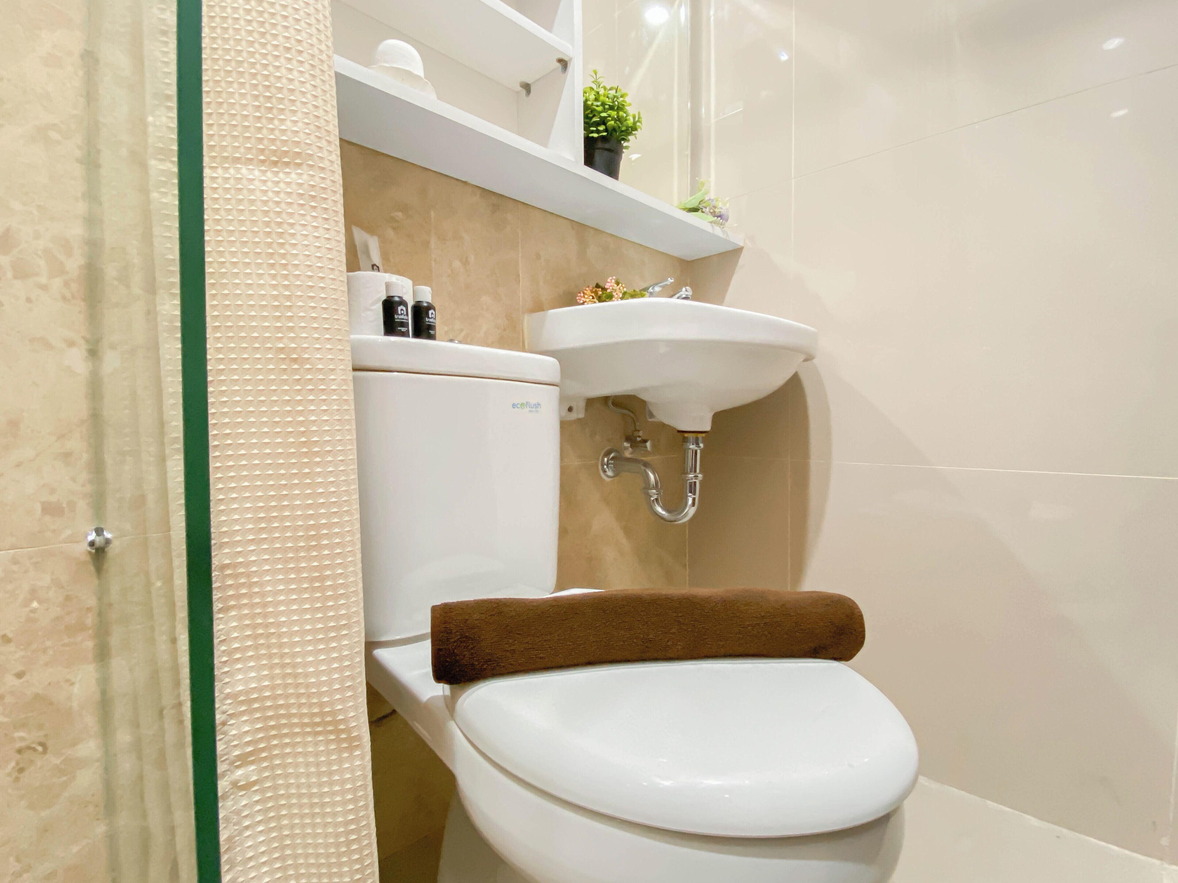 A modern bathroom with a toilet, a sink, and a shower area.