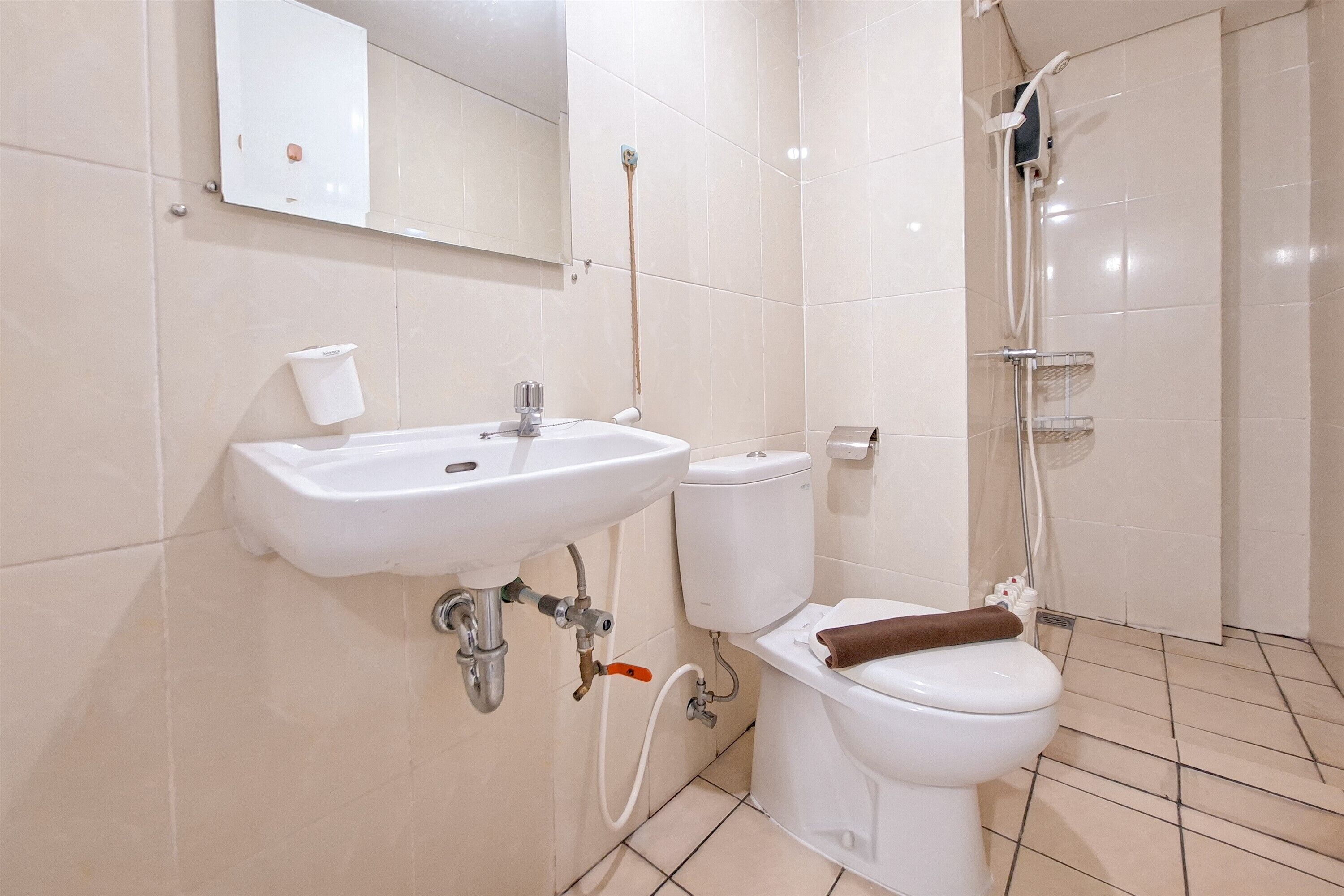 A modern bathroom with a sink, toilet, and shower.
