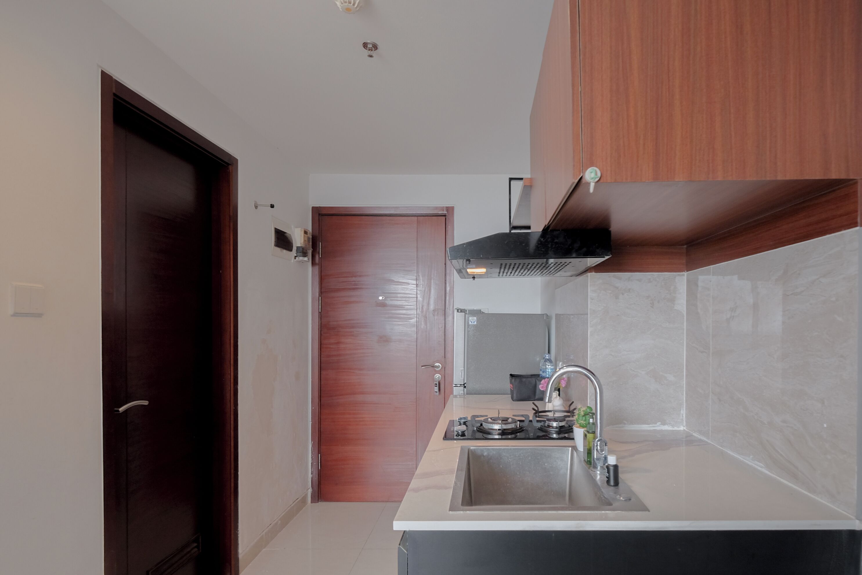 A compact kitchen with a sink, stove, and cabinets.