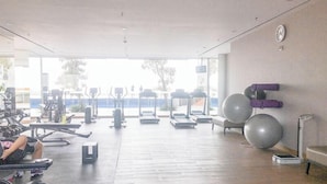A gym with exercise equipment, treadmills, and large exercise balls.