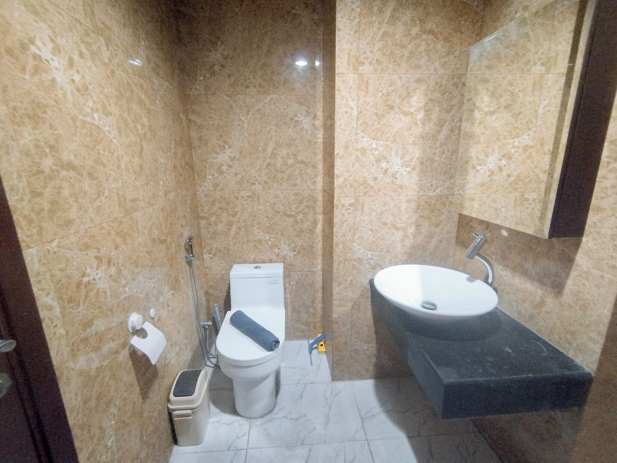 A bathroom with a toilet, bidet, and sink.