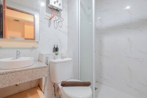 A bathroom with a sink, toilet, and shower. - Simple 1Br Without Living Room At Grand Kamala Lagoon Apartment (Bekasi)