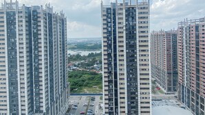 A high-rise residential building with multiple floors, large windows, and a parking area in front. - Modern Style 2Br Apartment At Meikarta (Cikarang)