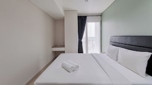 A hotel room with a neatly made bed, a small bedside table, and a window with curtains. - Simply Look 1Br Apartment Patraland Amarta (Ngaglik)