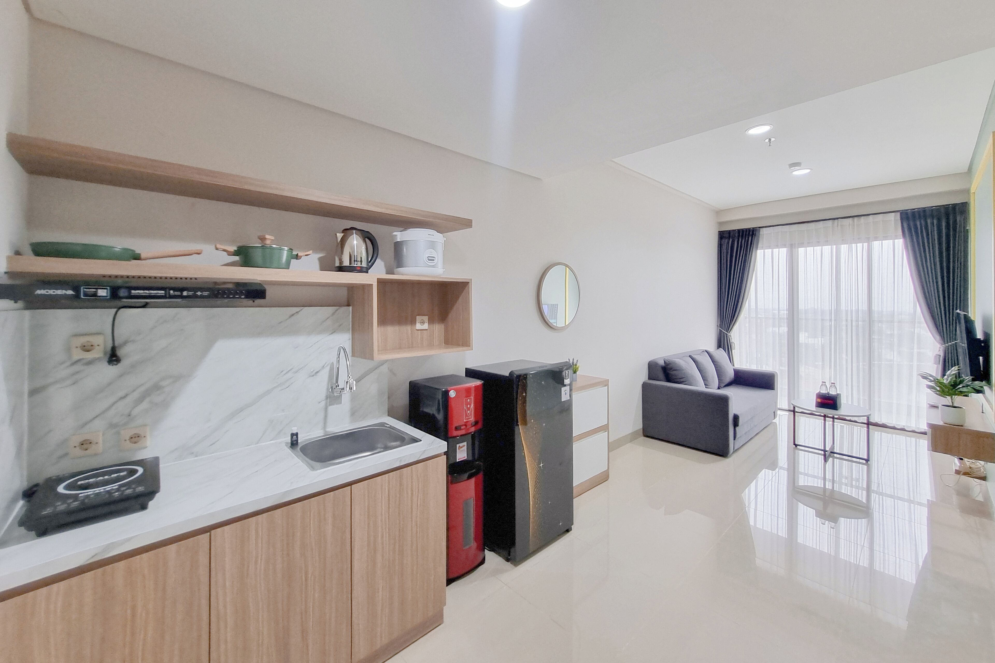 A modern kitchen with a marble countertop, wooden cabinets, and a built-in coffee machine.