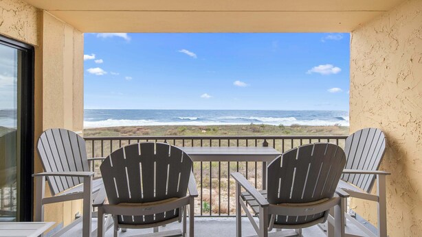 A balcony with two Adirondack chairs facing a beach view. - Surf's Edge 305  Pet Friendly (Ocean City)