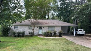 A single-story brick house with a covered porch and a car parked inside. - Perfect 3 bed 2 bath football weekend house. 10 minute walk to the square. (Oxford)