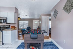 A compact living space with a kitchenette, a foosball table, and a dining area. - Pool and fooseball 3-bedroom house in Sarasota (Sarasota)