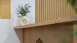 Un mostrador de recepción con detalles de madera y un emblema decorativo.