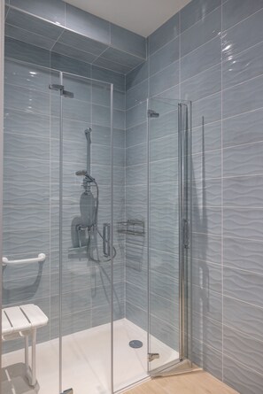 Shower, hair dryer, towels, toilet paper